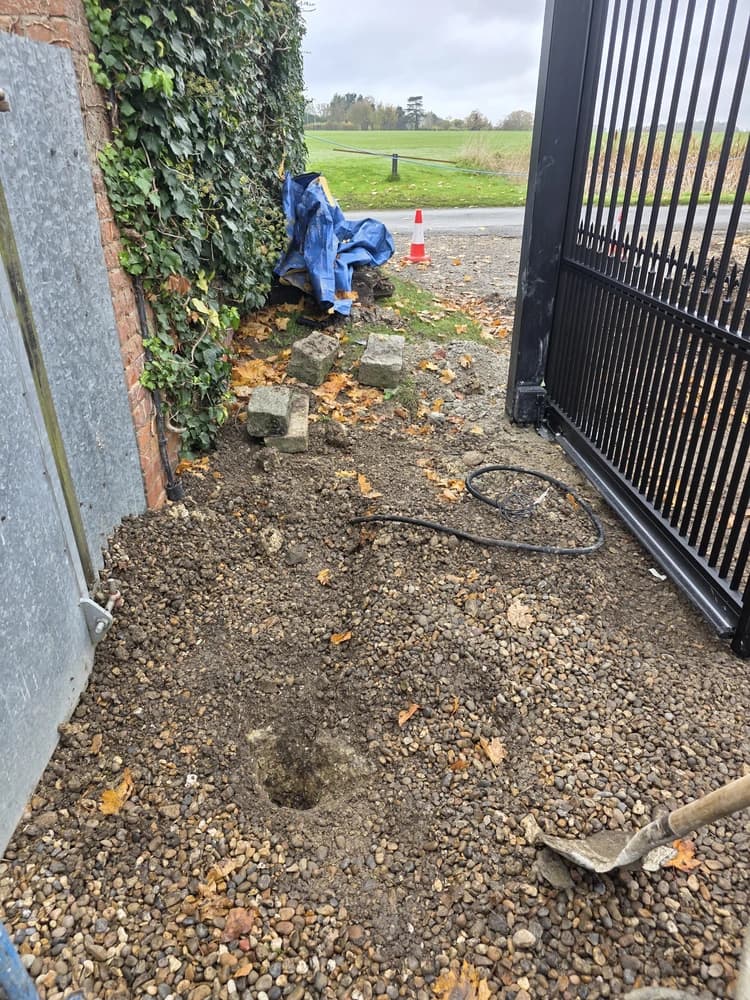 Groundwork and cabling being run during a driveway gate installation