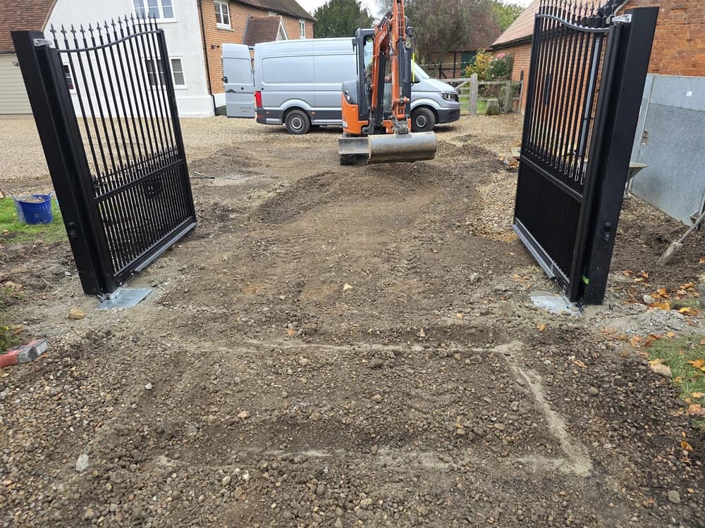 Newly installed black metal estate gates standing open